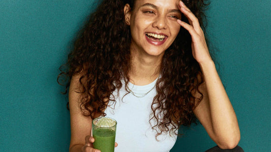 Woman drinking green healthy juice